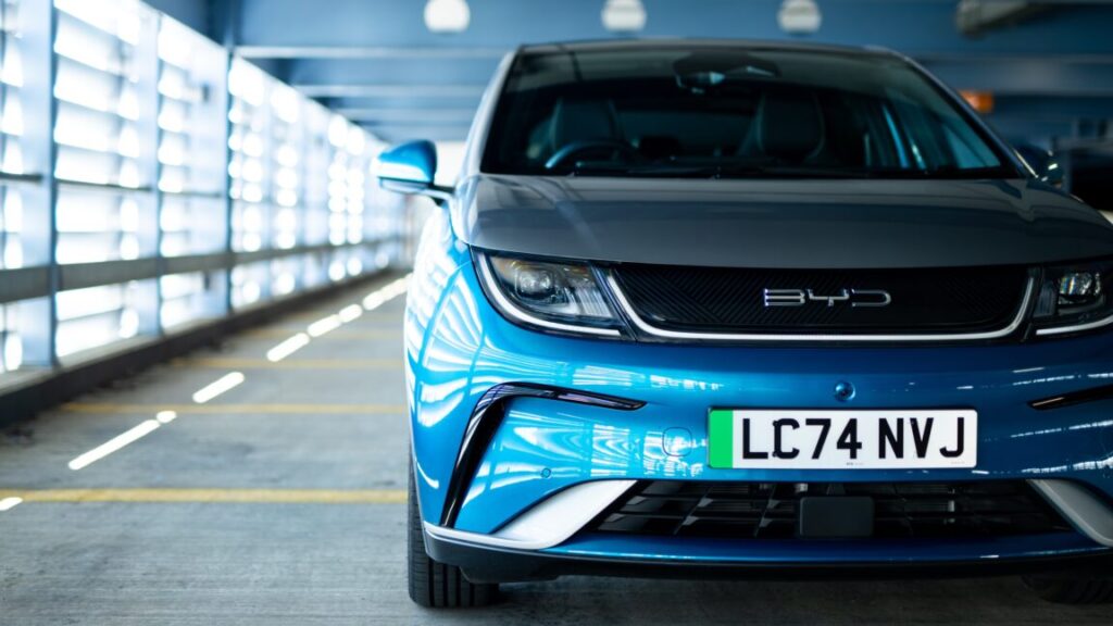 The front of a BYD Dolphin, inside a parking structure.