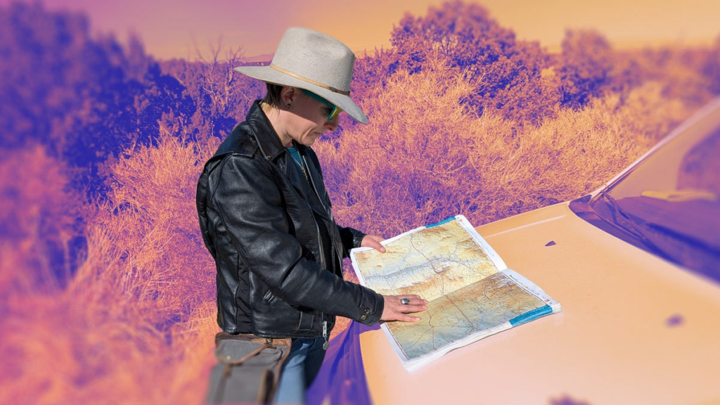 Writer Amanda checks out a map on the hood of her car during a day without the internet.