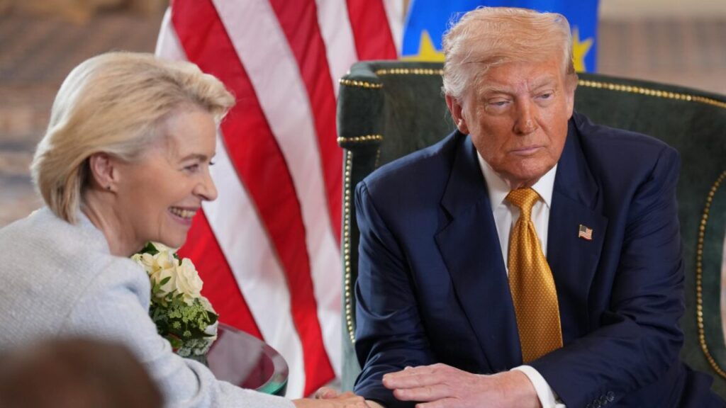US President Donald Trump and European Commission President Ursula von der Leyen sit in chairs and shake hands .