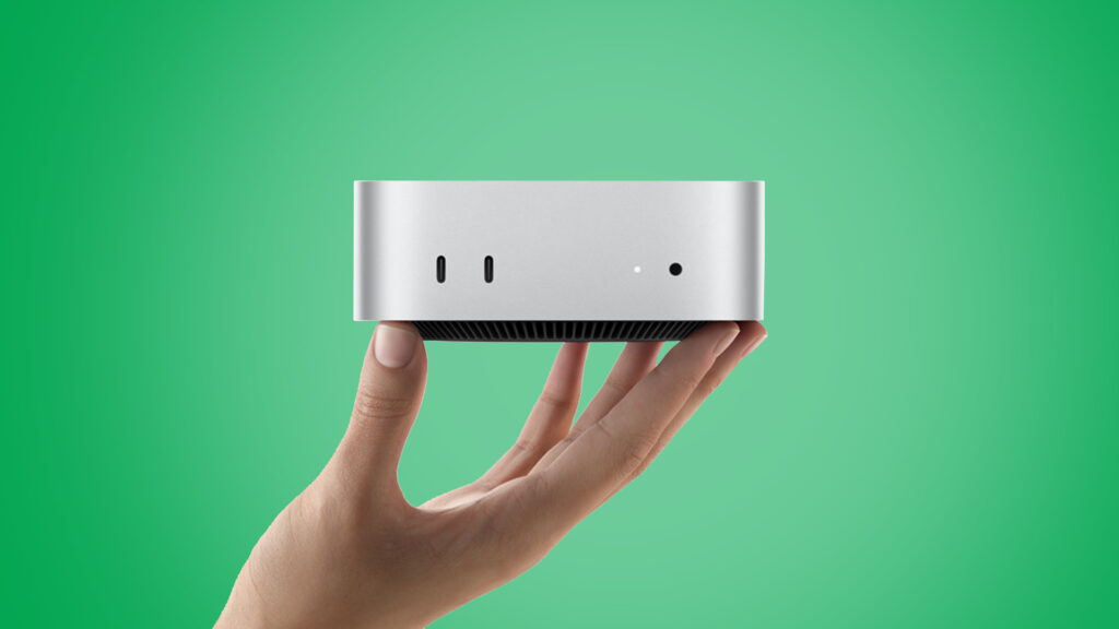 The Apple Mac mini held aloft.