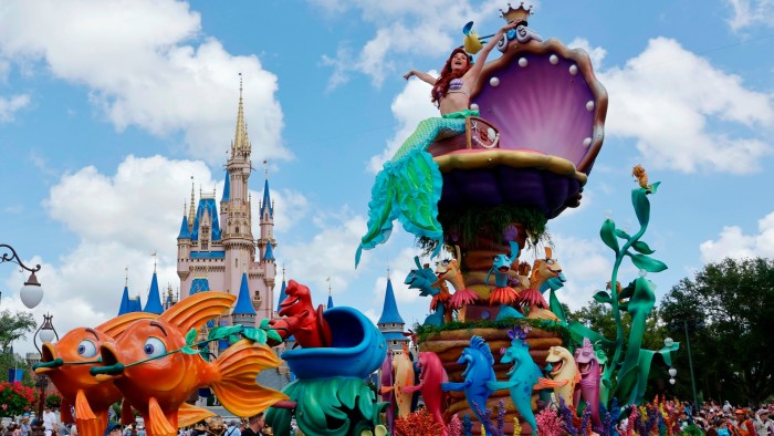 Disney raises dividend and buybacks as theme parks defy downturn fears The Little Mermaid float with Ariel and colourful sea creatures passes Cinderella's Castle during the Festival of Fantasy Parade.
