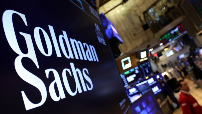 Goldman Sachs’ $110mn EA deal fee sets record for the bank A large screen on the New York Stock Exchange trading floor displays the Goldman Sachs logo prominently.