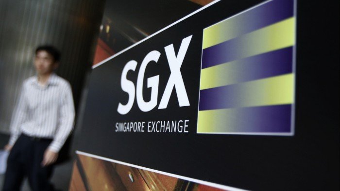 Nasdaq and Singapore’s SGX to allow simultaneous joint listings A person walks past a large SGX logo sign outside a building.
