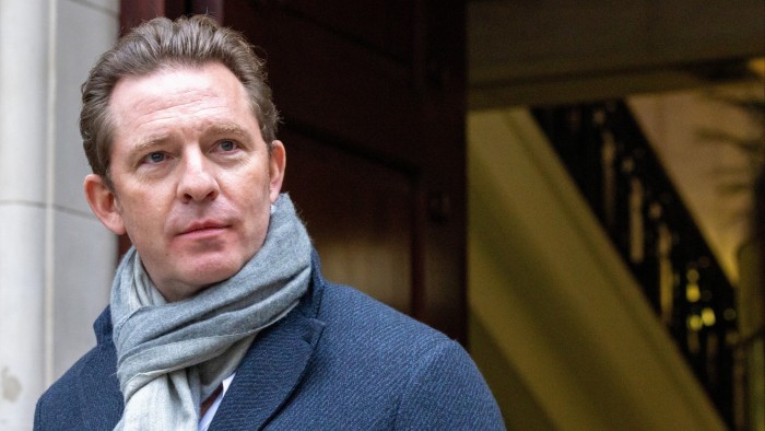 Reform UK treasurer Nick Candy wins fraud claim against tech boss Nick Candy stands outside a building in London, wearing a blue coat and grey scarf.