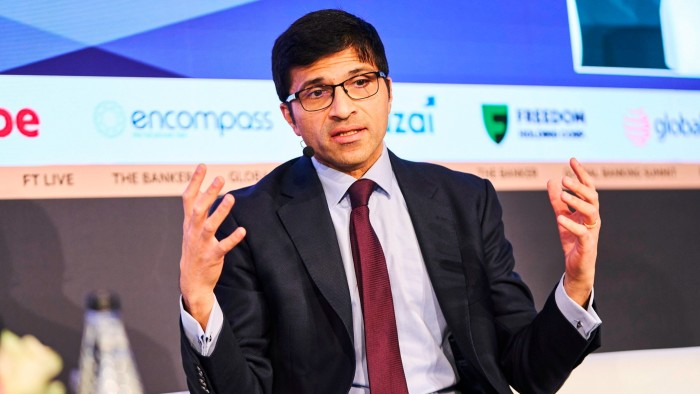 FCA boss promises more pro-growth measures in letter to Keir Starmer Nikhil Rathi speaks on stage, gesturing with both hands while wearing a suit, tie and headset microphone.