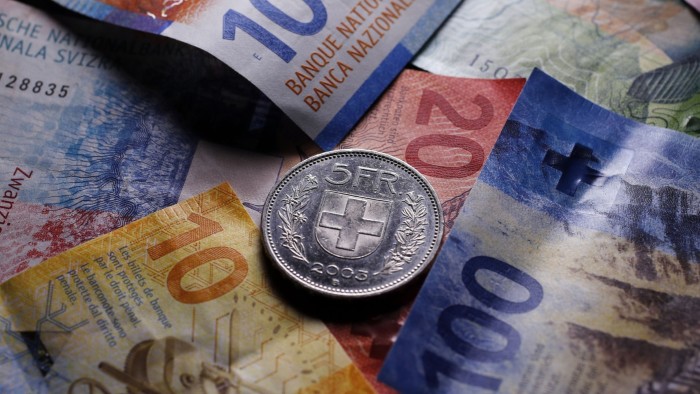 Swiss dealmaking surges to record highs despite strong franc A five Swiss franc coin rests on top of various Swiss franc banknotes, including denominations of 10, 20 and 100 francs.