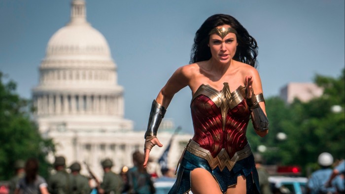 Why media titans are duelling to get Batman on the balance sheet Gal Gadot as Wonder Woman runs with a determined expression in front of the US Capitol in a scene from “Wonder Woman 1984”